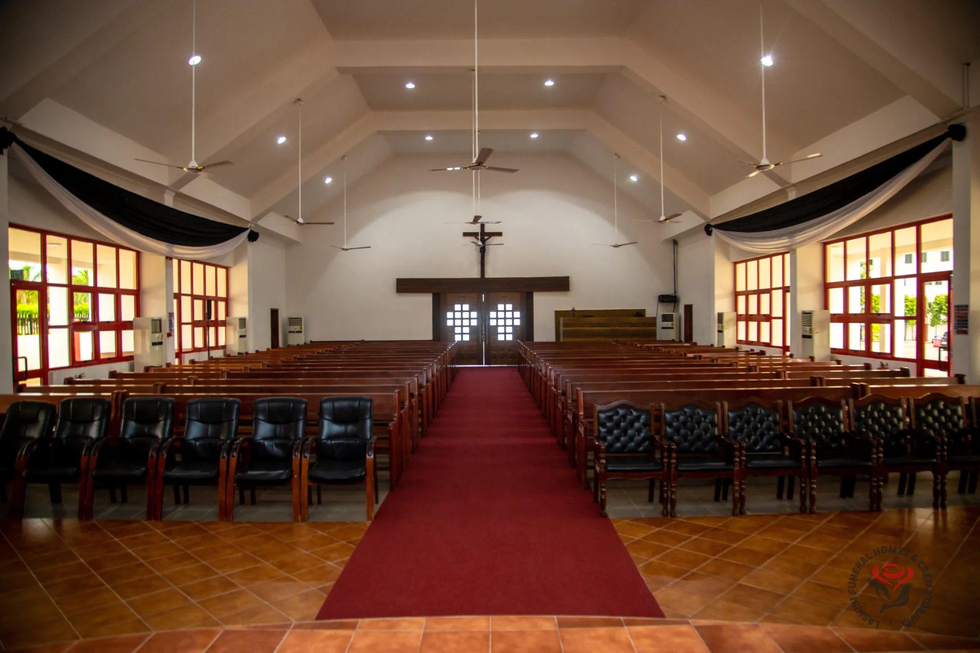 Inside All Souls' Chapel, the red carpeted aisle leading to the crucifix
