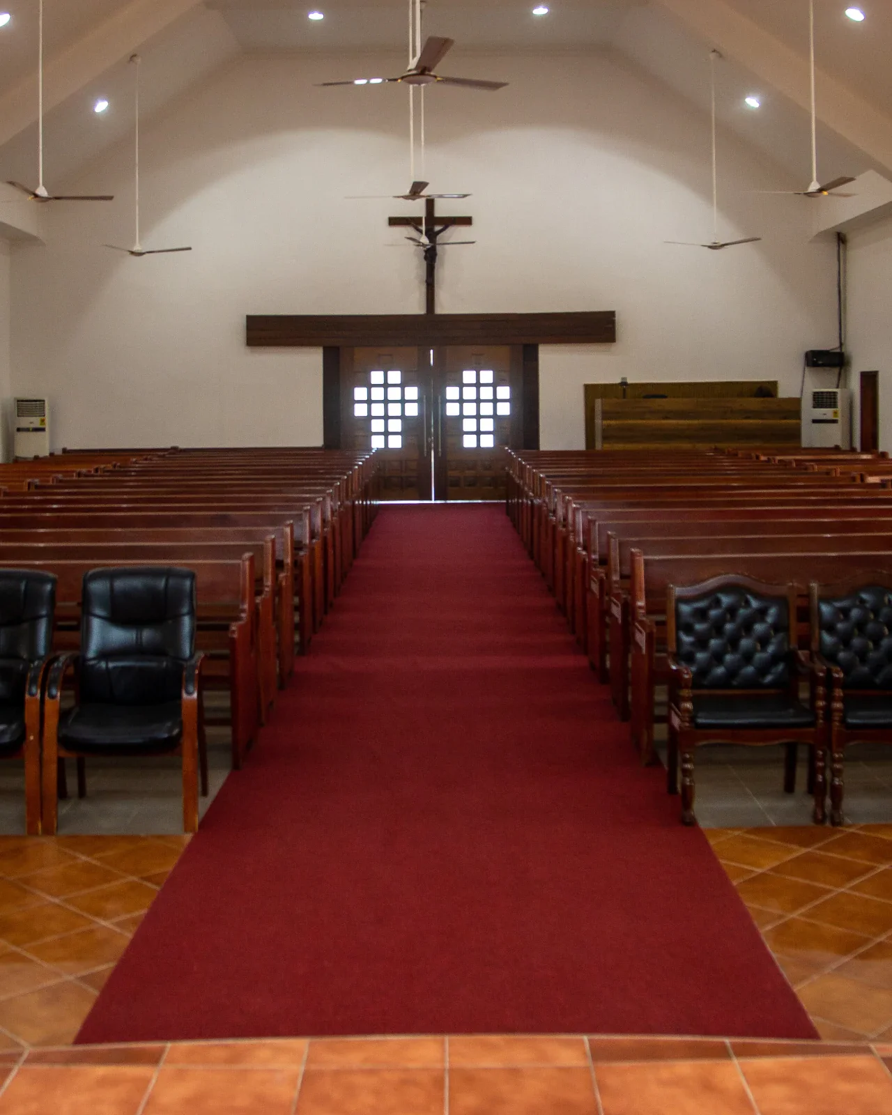 Inside All Souls' Chapel, the red carpeted aisle leading to the crucifix